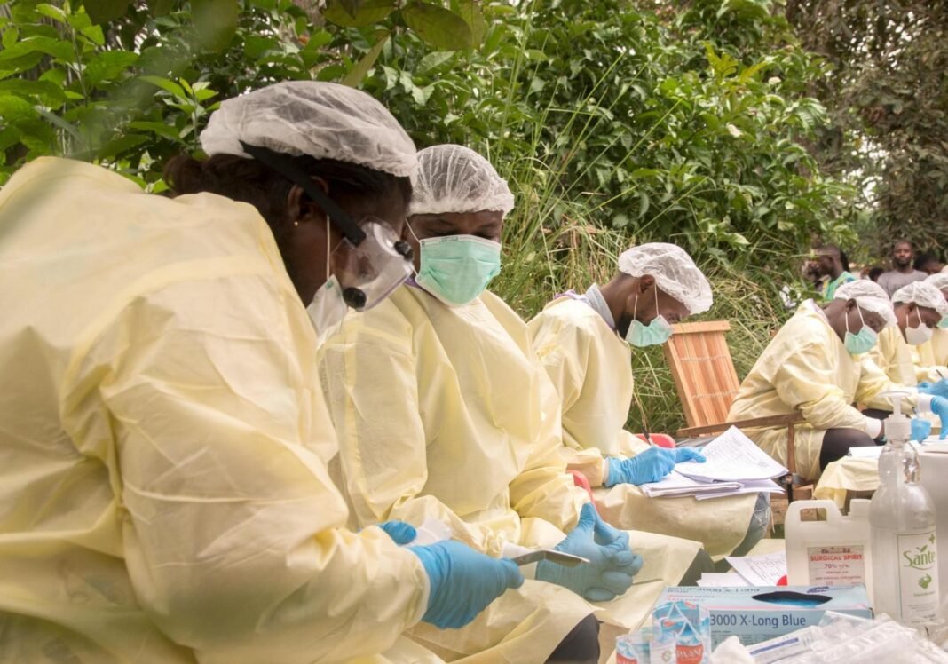 2026-10-16-india-congo-ebola-outbreak-new-province Health workers in protective equipment responding to an Ebola outbreak in the field