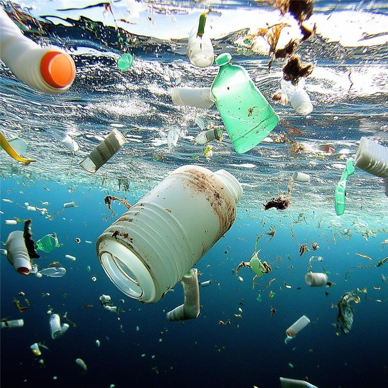 Microplastics floating in a glass of drinking water under magnification