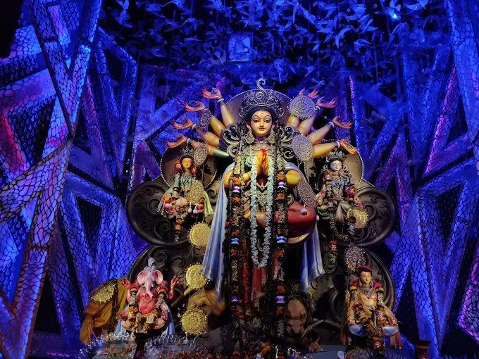 Decorated Durga Puja pandal in Kolkata glowing at night during the 2026 festive season