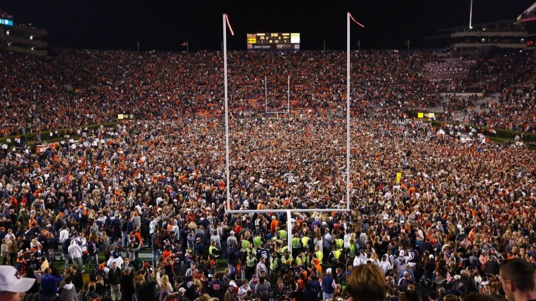 sports-02-college-football-predictions College football predictions: packed stadium crowd under goalposts at night