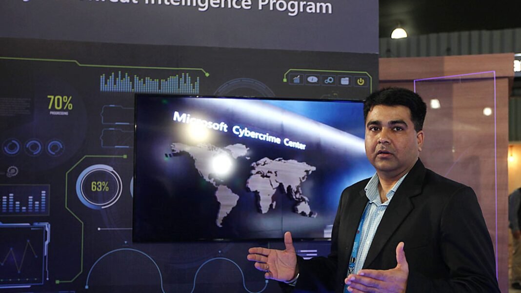 wp_12 Nicholas Butts Microsoft cybersecurity, cyber attack hacker dark screen, NDTV World Summit 2026 New Delhi, ransomware lock computer screen